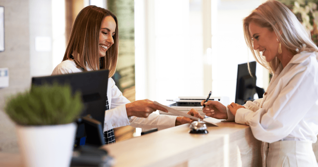 Dental receptionist welcoming a patient to the office